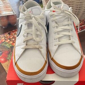 Nike White Leather Sneakers with Black Swoosh and Gold Trim